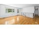 Bright living room with hardwood floors, a staircase, and a front door entry at 12829 E Nevada Ave, Aurora, CO 80012