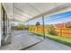 Covered patio offering a serene outdoor space with a view of the wooden fence and surrounding greenery at 12829 E Nevada Ave, Aurora, CO 80012