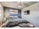 Spacious bedroom with hardwood floors, plush bedding, and ample natural light at 7625 W 23Rd Pl, Lakewood, CO 80214