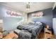 Bright bedroom with hardwood floors and neutral-toned bedding at 7625 W 23Rd Pl, Lakewood, CO 80214