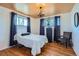 Well-lit bedroom with hardwood floors, chandelier, and neutral decor at 7625 W 23Rd Pl, Lakewood, CO 80214