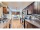 Modern kitchen with dark cabinets and stainless steel appliances at 7625 W 23Rd Pl, Lakewood, CO 80214