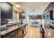 Modern kitchen with dark cabinets and stainless steel appliances at 7625 W 23Rd Pl, Lakewood, CO 80214