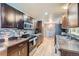 Modern kitchen features dark wood cabinets, tile backsplash, and stainless steel appliances at 7625 W 23Rd Pl, Lakewood, CO 80214