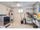 Laundry room with washer, dryer, shelving, and ample storage at 7625 W 23Rd Pl, Lakewood, CO 80214