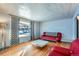 Living room with hardwood floors and red couches at 7625 W 23Rd Pl, Lakewood, CO 80214