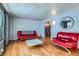 Living room with hardwood floors and red couches at 7625 W 23Rd Pl, Lakewood, CO 80214