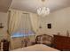 Elegant bedroom with crystal chandelier, soft lighting, and stylish furnishings at 8500 E Jefferson Ave, Denver, CO 80237