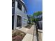 Inviting gray home exterior with a walkway leading to the front door and lush landscaping at 8500 E Jefferson Ave, Denver, CO 80237