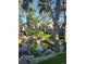 Beautiful community exterior view with lush greenery, mature trees, and a serene pond at 8500 E Jefferson Ave, Denver, CO 80237