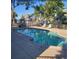 Community pool area with lounge chairs, tables, and umbrellas for residents at 8500 E Jefferson Ave, Denver, CO 80237