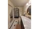 Bright bathroom with a glass-enclosed shower, modern vanity, and patterned tile floor at 8500 E Jefferson Ave, Denver, CO 80237