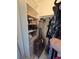 Organized closet with shelves, drawers, hanging space, and a suitcase at 8500 E Jefferson Ave, Denver, CO 80237