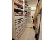 Well-organized walk-in closet with built-in shelving and ample storage space at 8500 E Jefferson Ave, Denver, CO 80237