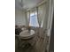 Cozy dining nook with floral curtains, natural light, and wood-look flooring at 8500 E Jefferson Ave, Denver, CO 80237