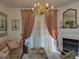 Cozy living room with a fireplace, chandelier, and elegant furnishings at 8500 E Jefferson Ave, Denver, CO 80237