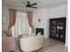 Comfortable living room with a fireplace, ceiling fan, and built-in cabinet at 8500 E Jefferson Ave, Denver, CO 80237