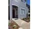 Charming townhouse exterior with gray siding, neatly landscaped front yard, and red door at 8500 E Jefferson Ave # G, Denver, CO 80237