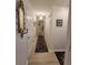 Bright hallway with hardwood floors, decorative mirror, and white doors at 8500 E Jefferson Ave # G, Denver, CO 80237