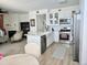 Open concept living area featuring a white kitchen with stainless steel appliances and views of a living room with fireplace at 8500 E Jefferson Ave # G, Denver, CO 80237
