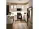 Well-lit kitchen with stainless steel appliances, white cabinets, and a stylish island with sink at 8500 E Jefferson Ave # G, Denver, CO 80237