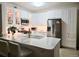 Modern kitchen featuring a large island with quartz countertops and stainless steel appliances and white cabinets at 8500 E Jefferson Ave # G, Denver, CO 80237
