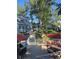 Community outdoor patio with grill, dining table and seating, and lush landscaping at 8500 E Jefferson Ave # G, Denver, CO 80237