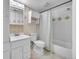 Bright bathroom features a shower-tub combo, toilet, and vanity with ample storage space at 6410 S Dayton St # I1, Englewood, CO 80111