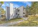Exterior view of a multi-story condo with gray siding, a chimney, and a well-maintained lawn at 6410 S Dayton St # I1, Englewood, CO 80111