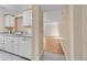 Clean kitchen with white cabinets and a view into the adjacent living room at 6410 S Dayton St # I1, Englewood, CO 80111