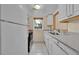 Functional kitchen with white cabinets, a window, and essential appliances at 6410 S Dayton St # I1, Englewood, CO 80111