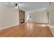 Spacious living room featuring hardwood floors, a stone fireplace, and a ceiling fan at 6410 S Dayton St # I1, Englewood, CO 80111