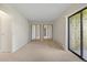 Bedroom with mirrored closet doors and access to a private balcony at 14000 E Linvale Pl # 107, Aurora, CO 80014