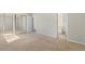 Spacious bedroom with mirrored closet doors and adjacent bathroom at 14000 E Linvale Pl # 107, Aurora, CO 80014