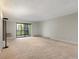 Spacious living room featuring a large window and neutral walls at 14000 E Linvale Pl # 107, Aurora, CO 80014