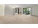 Large living room with wall-to-wall carpeting and sliding glass doors at 14000 E Linvale Pl # 107, Aurora, CO 80014