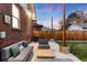 Cozy backyard patio with seating area, string lights, and wooden accents at 4270 Irving St, Denver, CO 80211