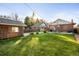 Large backyard with grassy lawn, detached garage, and mature trees at 4270 Irving St, Denver, CO 80211