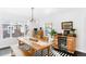 Bright dining room features a wood table, built-in bar, and stylish light fixture at 4270 Irving St, Denver, CO 80211