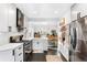 Bright kitchen with stainless steel appliances and white shaker cabinets at 4270 Irving St, Denver, CO 80211