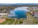Beautiful aerial view showcases a serene lake surrounded by lush greenery and a charming residential community at 4544 W 65Th Ave, Arvada, CO 80003