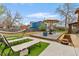 Inviting backyard space with a deck, dining area, hammock, and lounge chairs for outdoor relaxation and entertainment at 4544 W 65Th Ave, Arvada, CO 80003