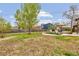 Expansive backyard features a partially finished landscape with a deck, dining set, and ample space for outdoor enjoyment at 4544 W 65Th Ave, Arvada, CO 80003