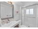 Modern bathroom with tiled shower, sleek vanity, and stylish mirror at 4544 W 65Th Ave, Arvada, CO 80003