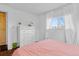 Well-lit bedroom featuring hardwood floors, a window with white curtains and a white dresser at 4544 W 65Th Ave, Arvada, CO 80003
