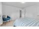 Bright bedroom features striped bedding, comfortable chair, and neutral carpet at 4544 W 65Th Ave, Arvada, CO 80003