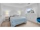 Bright bedroom features striped bedding, white walls, and natural light from window with sheer curtains at 4544 W 65Th Ave, Arvada, CO 80003