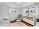 Bedroom with hardwood floors, a cozy chair, and plenty of storage at 4544 W 65Th Ave, Arvada, CO 80003