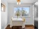 Bright dining area with a table set for four, hardwood floors, and a view of the outdoors at 4544 W 65Th Ave, Arvada, CO 80003