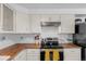 Bright kitchen with white cabinets, subway tile backsplash, and stainless steel range at 4544 W 65Th Ave, Arvada, CO 80003